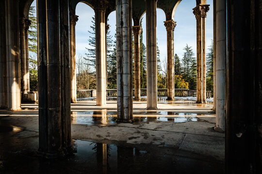 Arched columns of the abandoned Medea Sanatorium in Tskaltubo, Georgia. Winter light, decaying elegance, and classical architecture evoke a haunting beauty of forgotten grandeur
