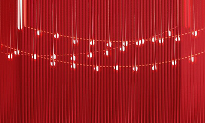 Abstract Red Ribbed Background with Glowing Fairy Lights and Vertical Fluted Texture for Festive Design