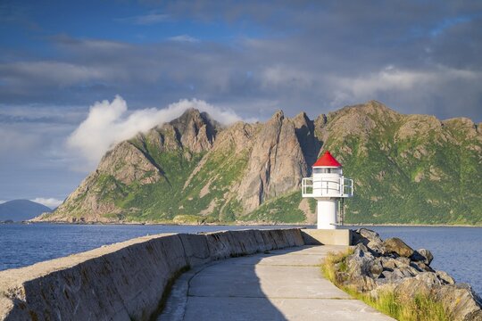 Lighthouse at harbour wall, fishing village Hovden, island Lang&oslash;ya, archipelago Vester&aring;len, Norway