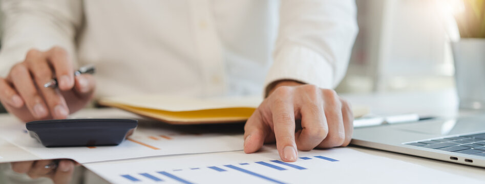 Deduction planning, debt asian accountant hand using calculator to calculating money balance from bill and income, cost budget expenses for pay money form personal individual on table at home.