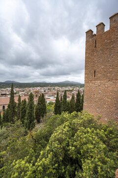 Fortified defence tower of the old castle, view of Art&aacute; with Transfiguracio del Senyor parish church, Santuari de Sant Salvador monastery on Calvary, Art&aacute;, Majorca, Balearic Islands, Spain