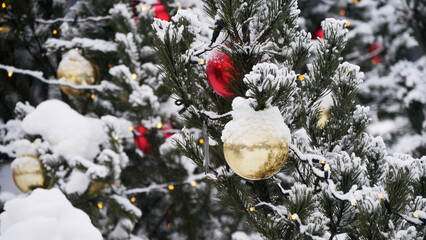 Christmas Tree toys covered with snow on the outdoor Christmas tree