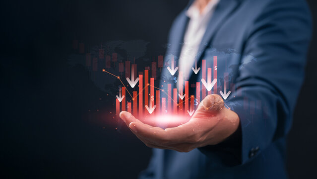financial market downturn and global economic crisis. businessman holding falling red stock charts, symbolizing crisis, investment loss, inflation impact, and bearish trend across world economy