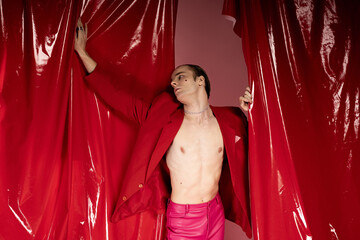 Bold celebration of love and identity featuring a man in vibrant red attire