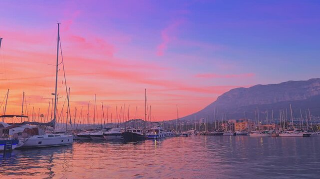 Denia marina sunset with sailboats and Montgo mountain
