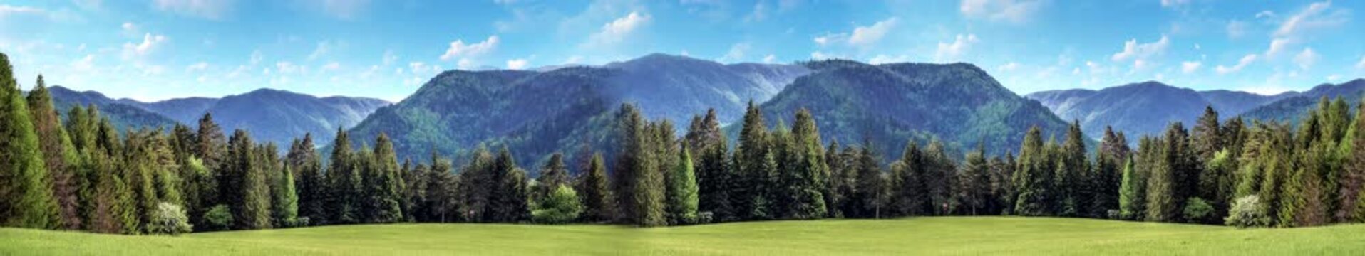 Lush green mountains with rolling green fields, creating a vibrant natural landscape | widescreen | looped animation