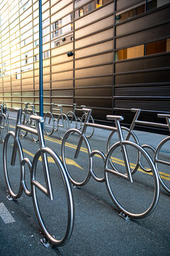 Empty urban street bicycle rack for parking showing transport mobility with metal loops and modern architecture in daylight clean scene