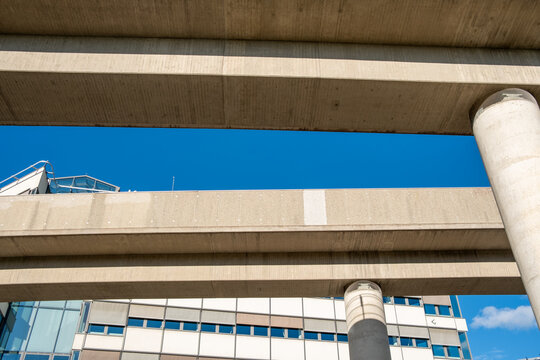 Modern concrete viaduct bridge with columns showing transport infrastructure and architecture under blue sky structure bold geometry