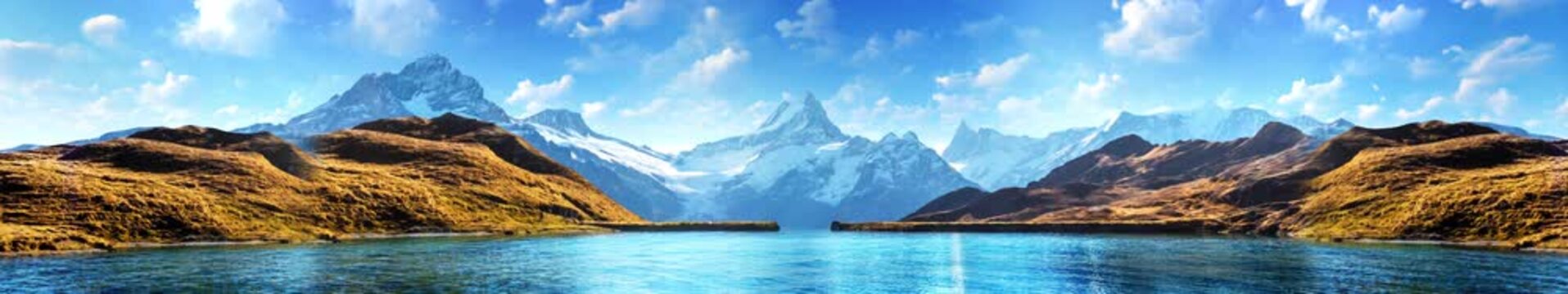 Mountain lake set against a backdrop of snow-capped mountains, creating a serene alpine landscape | widescreen | looped animation
