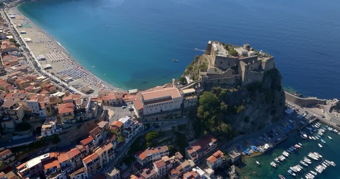 Aerial view of the town of Scilla, in the province of Reggio Calabria, Italy. In the foreground is the historic center with the castle and the main church. In the background is the town beach.