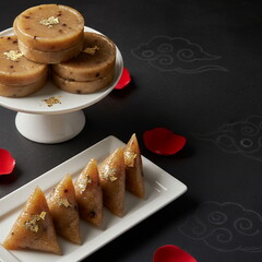 Generated ai Luxurious Traditional Chinese New Year Rice Cakes Decorated with Gold Leaf, Set on Elegant White Plates Against a Sophisticated Dark Background with Auspicious Cloud Patterns and Rose P
