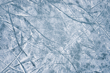 Closeup Ice hockey rink texture with skate marks or scratches. Outdoor area icy winter background top view