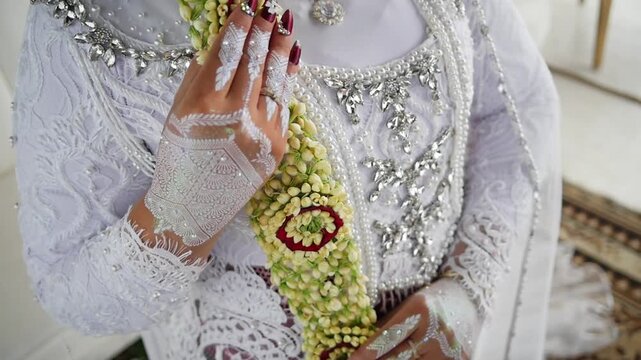Traditional Southeast Asian white wedding dresses complete with decorations and ornaments, and are worn by the bride and groom. Real time outdoor natural lighting RAW no edit footage video file
