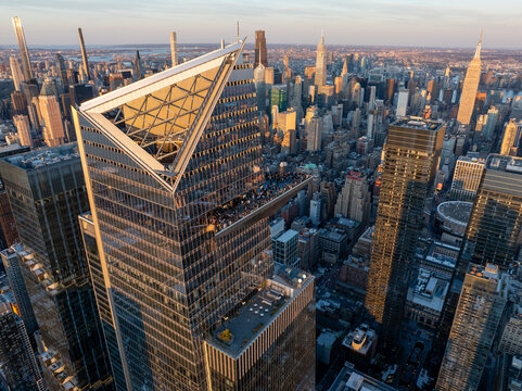 Aerial view of the angular, modern Edge observation deck at 30 Hudson Yards piercing the skyline, with sunlit towers beyond, New York, New York, United States.