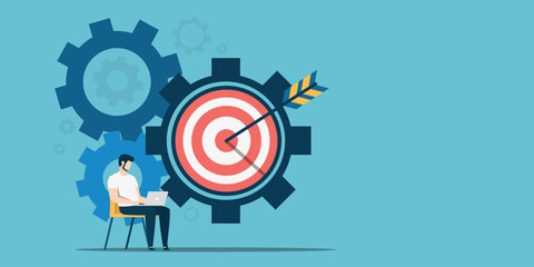 Flat design of a man using a laptop seated next to large interlocking gears and a bullseye with an arrow. It represents strategic planning, technical precision, and hitting business targets.