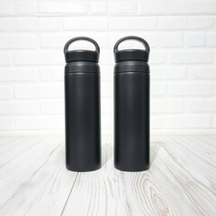 Obraz premium Two Matte Black Stainless Steel Water Bottles Mockup