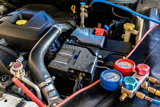 A/C Manifold Gauges Set. Check pressure and leak for use air conditioning systems. Recharging car air conditioner with refrigerant using grade gear with separate gauges to monitor pressure in system.