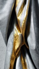 Close-up of matte silver foil with glossy gold streaks in sculptural folds. Illuminated by a spotlight, this high-end texture exudes luxury and refinement.
