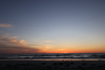 Fototapeta premium All about the peacefulness and the darkening colors of the sky over the ocean at sunset in Florida. 