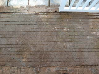 Weathered Concrete with Grooves and White Fence