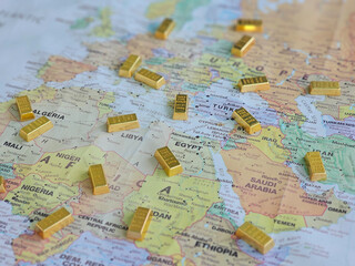 Fototapeta premium Gold bars placed on a map showing countries in Europe, Africa, and the Middle East with borders