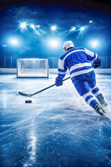 Rear view of ice hockey player in blue uniform attacking goal