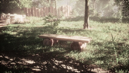 In a serene forest, a simple wooden bench rests on the grass, surrounded by lush greenery. Beams of soft morning sunlight filter through the trees, creating a peaceful atmosphere.