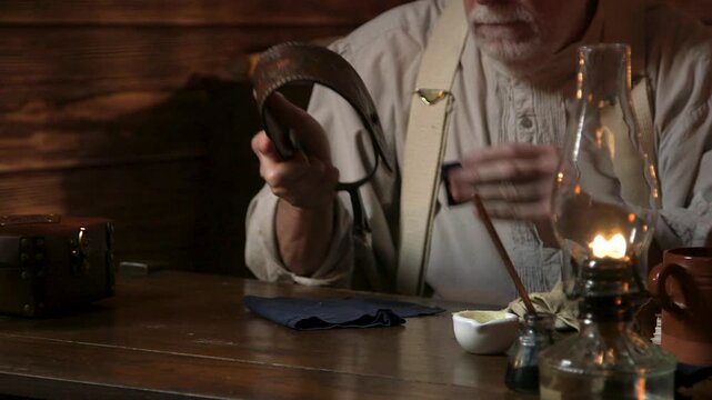 1890s cowboy cleaning his spurs