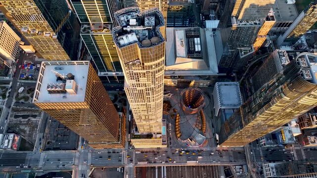 Aerial view of glass skyscrapers at Hudson Yards, their surfaces reflecting light, contrasting with the shadows of surrounding buildings, New York, New York, United States.