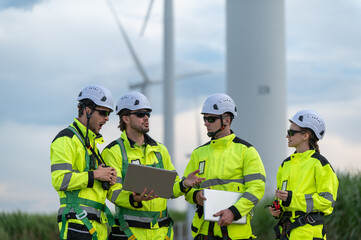 Engineers working on site in wind turbine farm, Wind turbines generate clean energy source, Eco...