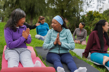 Happy multiracial women circle having fun together outdoor - Community, international female group...