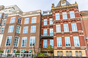 Fototapeta premium Canal Houses red brick wall facade of Amsterdam City in Netherlands street building architecture.