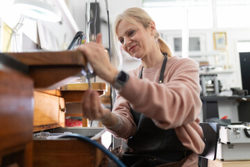 Woman jeweler crafting handmade luxury accessories in workshop