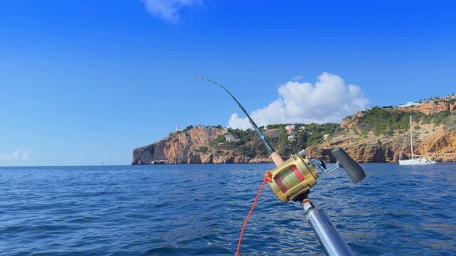 Costa Blanca trolling fishing rods on boat near Cape de la Nao in Alicante