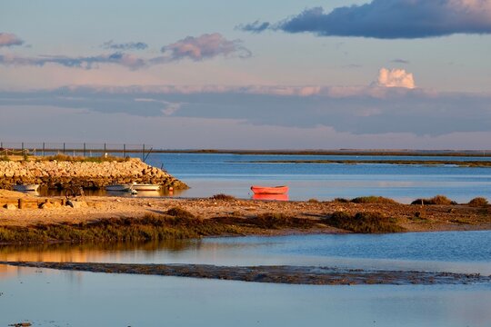 The light of the sunset bathes the Ria Formosa Natural Park in Olh&atilde;o in a wonderful glow. Olh&atilde;o, Algarve, Portugal, Europe