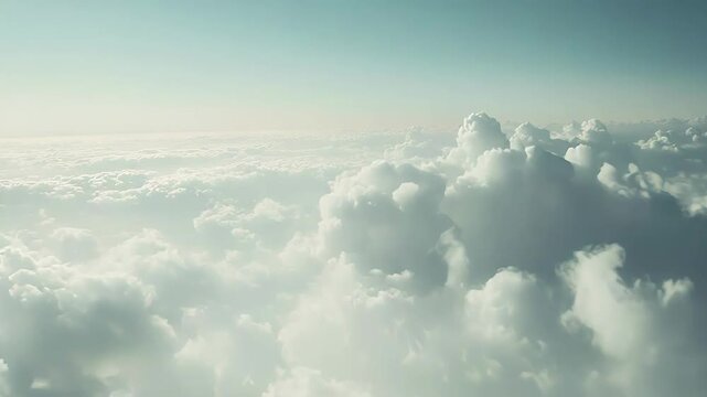 Clouds forming a vast, dreamy landscape, seen from an aerial perspective, symbolizing freedom, travel, clear thinking, and new beginnings against a soft blue sky