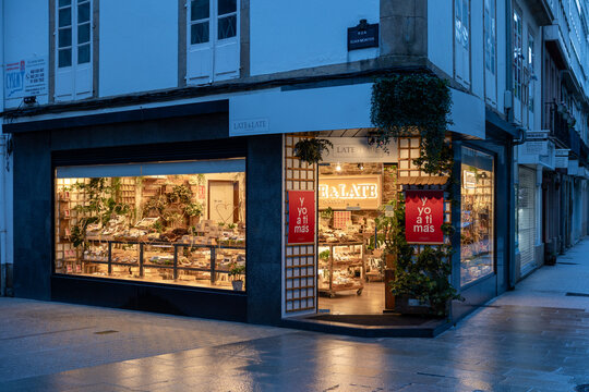 Lugo, spain; 01 25 2026 corner store with illuminated storefront at evening on european street