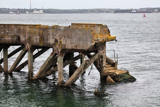 Crumbling infrastructure damaged by sea water and weather. Concrete spalling (also known as concrete cancer) in Cobh harbor in Ireland.
