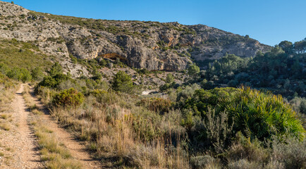 Obraz premium Panorama of a rocky hill landscape with a cave, Spain