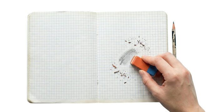 Hand holding eraser cleaning pencil marks on grid paper notebook open isolated on transparent background
