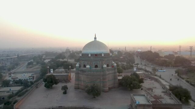 Aerial view of the Tomb of Shah Rukn-e-Alam with its white dome and brickwork against a muted, hazy backdrop, Multan, Punjab, Pakistan.
