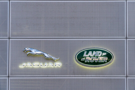The facade of the land Rover, Jaguar car store. Entrance in showroom of dealership office building. British car manufacturer Jaguar Land Rover, Bentley.
