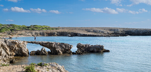 The quiet bay named Cala Rotonda, with a natural arch and unique sunsets on the isle of Favignana, Trapani province, Sicily, Italy.