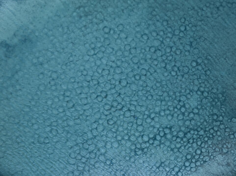 Aerial view of a sea surface, the light reflecting off the water creating a shimmering, textured effect, Stintino, Sardegna, Italy.