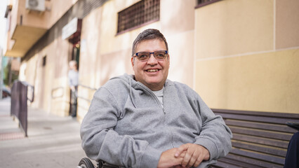Fototapeta premium Happy man with disability in wheelchair actively participating in urban life. Accessibility and inclusion are key concepts