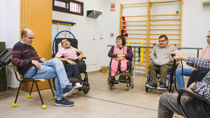 Group of diverse people with disabilities participating in a support meeting or therapy session at a rehabilitation center