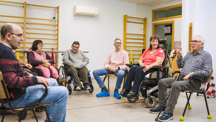 Adults with varying disabilities engaged in a group therapy discussion, fostering community, rehabilitation, and inclusion