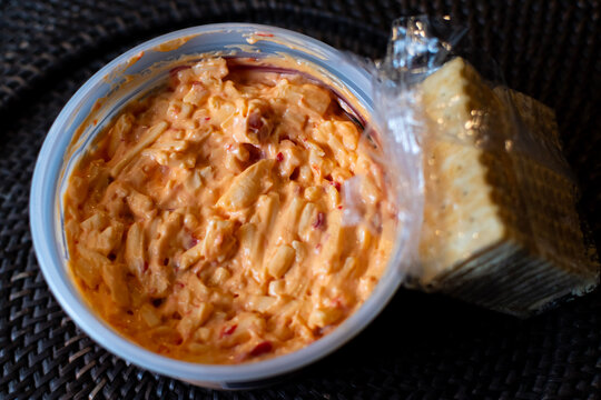 Pimento cheese and crackers with plastic wrapper from directly above. 