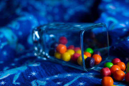 Square glass shot glass of colorful bite sized candy. 