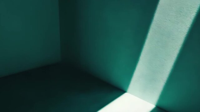 Stark light rays illuminating the interior corner of a teal colored room, casting sharp shadows and highlighting the textured surface, symbolizing a new path or perspective